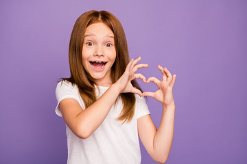 Photo of pretty little foxy lady making heart figure with fingers symbolizing children cardiac...