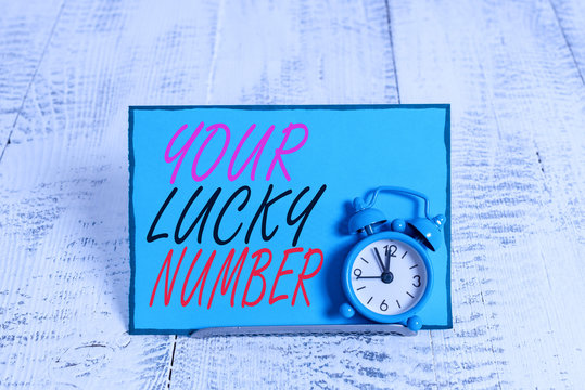 Conceptual hand writing showing Your Lucky Number. Concept meaning believing in letter Fortune Increase Chance Casino Alarm clock tilted above buffer wire in front of notepaper