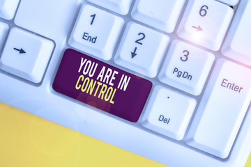Text sign showing You Are In Control. Business photo showcasing Responsibility over a situation Management authority White pc keyboard with empty note paper above white background key copy space