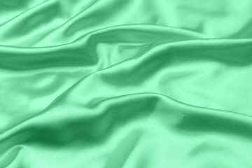 green satin fabric texture soft blur background