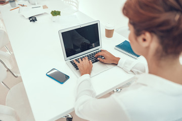 Fototapeta na wymiar Screen of modern laptop and woman typing on keyboard stock photo