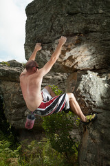 A rock climber ascending a bolder in Mpumalanga, South Africa.