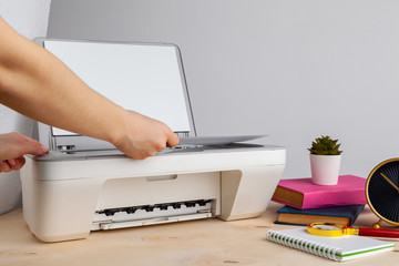 Close up of woman using a printer machine