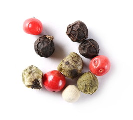 Colorful pepper pile isolated on white background, top view, macro