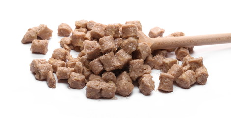 Dog, cat food pile with wooden spoon isolated on white background