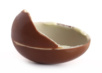 Broken chocolate egg with pieces isolated on white background