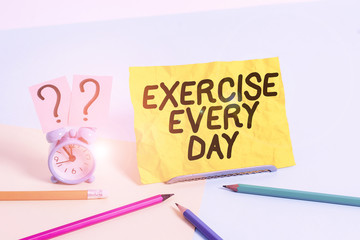 Text sign showing Exercise Every Day. Business photo text move body energetically in order to get fit and healthy Mini size alarm clock beside stationary placed tilted on pastel backdrop
