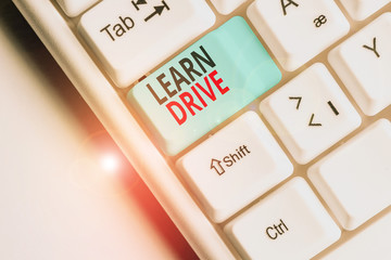 Writing note showing Learn Drive. Business concept for to gain the knowledge or skill in driving a...