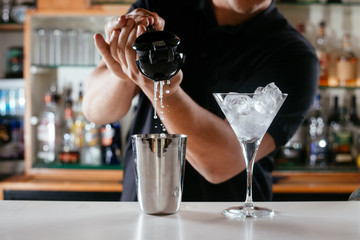 Barman making cocktail on bar counter