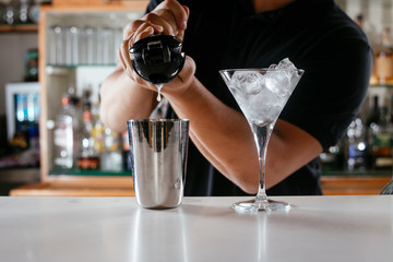 Barman making cocktail on bar counter