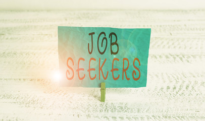 Word writing text Job Seekers. Business photo showcasing an unemployed demonstrating who is actively looking for employment Green clothespin white wood background colored paper reminder office supply