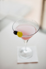 Cosmopolitan cocktail served on bar counter