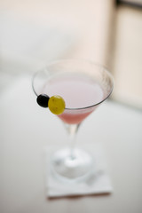 Cosmopolitan cocktail served on bar counter