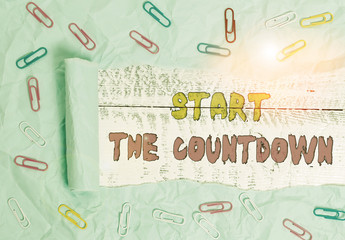 Writing note showing Start The Countdown. Business concept for Sequence of Backward Counting to Set the Timer Paper clip and torn cardboard on wood classic table backdrop