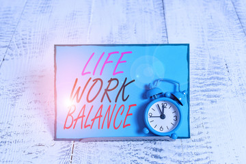 Conceptual hand writing showing Life Work Balance. Concept meaning stability demonstrating needs between his job and demonstratingal time Alarm clock tilted above buffer wire in front of notepaper