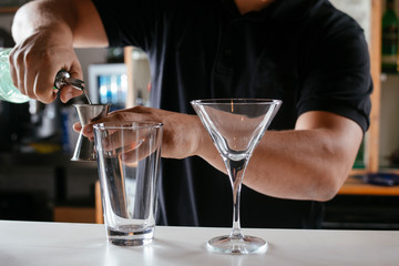 Barman making cocktail on bar counter