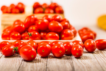 chery tomatoes on wooden board with linen sack, selective focus