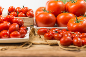 chery tomatoes on wooden board with linen sack, selective focus