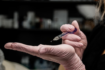 contour plastic. A cosmetologist injects a botulinum toxin to tighten and smooth out wrinkles on the skin of a female face.