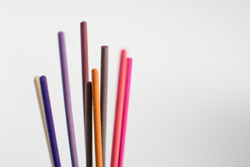 Colorful aromatic incense sticks isolated against white background. Meditation, mindfulness, buddhism and aromatherapy concept.