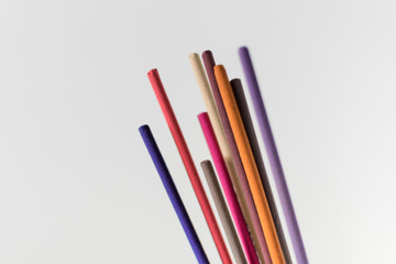 Colorful aromatic incense sticks isolated against white background. Meditation, mindfulness, buddhism and aromatherapy concept.