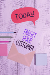 Writing note showing Target Your Customer. Business concept for Tailor Marketing Pitch Defining Potential Consumers Envelop speech bubble paper sheet ballpoints notepads wooden background