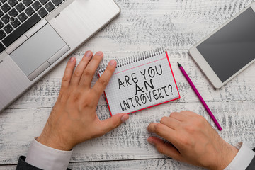 Writing note showing Are You An Introvertquestion. Business concept for demonstrating who tends to...