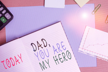 Handwriting text writing Dad You Are My Hero. Conceptual photo Admiration for your father love feelings compliment Striped paperboard notebook cardboard office study supplies chart paper