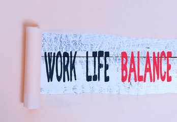 Writing note showing Work Life Balance. Business concept for Division of time between working or family and leisure Cardboard which is torn placed above a wooden classic table
