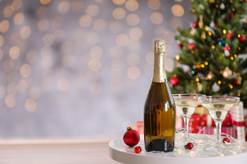 Beautiful christmas composition with two glasses of sparkling wine, decorations on textured table. New year's eve tradition to celebrate with champagne. Close up, copy space, background.