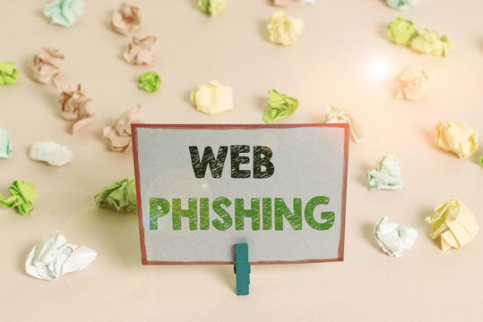 Writing note showing Web Phishing. Business concept for fraudulent attempt to obtain sensitive details by disguising Colored crumpled papers empty reminder pink floor background clothespin