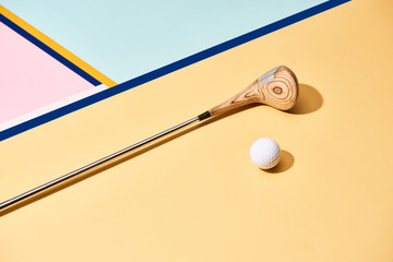 Golf club and ball on surface with blue lines