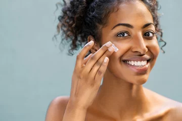 Poster Woman applying moisturizer on face © Rido