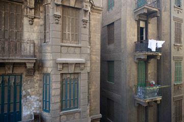 Laundry hangs from balcony of dusty buildings in the center of Cairo, Egypt