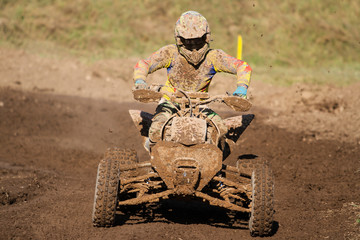 Motocross quad race with races who are covered with mud in an old motocross track. 