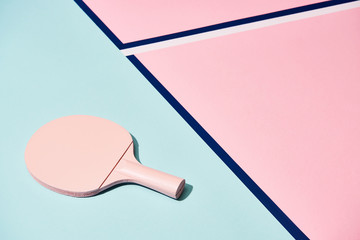 Tennis racket on pastel background with blue lines