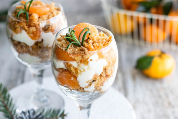 Citrus trifle with fresh tangerines. Christmas portioned dessert on the festive table.