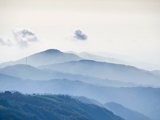 Obraz premium landscape with Silhouette of hills and Wind Power in the fog
