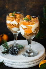Citrus trifle with fresh tangerines. Christmas portioned dessert on the festive table.