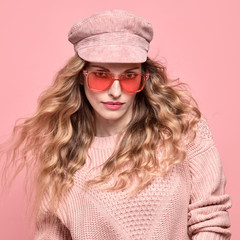 Fashionable lovable woman in Trendy pink outfit, stylish hairstyle, makeup smiling. Young blonde in jumper. Sensual beautiful model girl in stylish sunglasses, pastel fashion beauty concept on pink