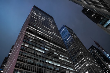 Naklejka premium skyscrapers in new york manhattan office condominium real estate leasing home apartment bluesky night photography wall street financial street