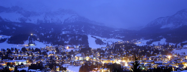 Aerial view of Cortina d'Ampezzo village under the snow on Christmas night, Italy