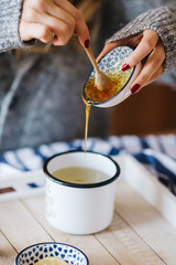 a warm tea to heat a cold winter. The girl is holding herbal tea. a cup of linden tea