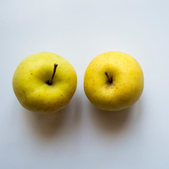 Organic yellow apple on white background 