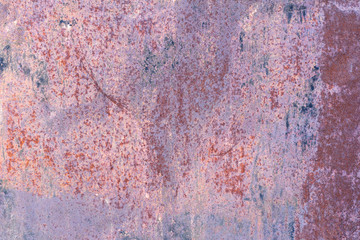 The corroded colored metal background.Rusty and scratched metal wall. Rusty metal background with rust spots.