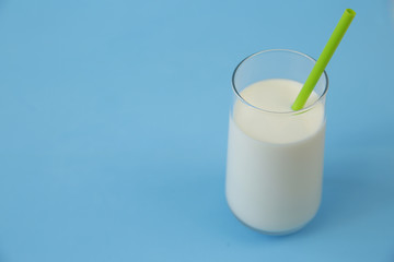 glass of milk or kefir on blue background with copy space for text. Dairy products.