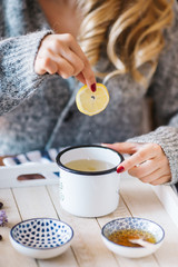 a warm tea to heat a cold winter. The girl is holding herbal tea. a cup of linden tea