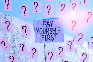 Text sign showing Pay Yourself First. Business photo showcasing Saving for future Setting aside a Portion of your income Scribbled and crumbling papers with thick cardboard above wooden table