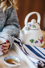 a warm tea to heat a cold winter. The girl is holding herbal tea. a cup of linden tea
