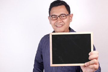 Young Asian Man Smiling and Presenting Empty Copy Space Blackboard